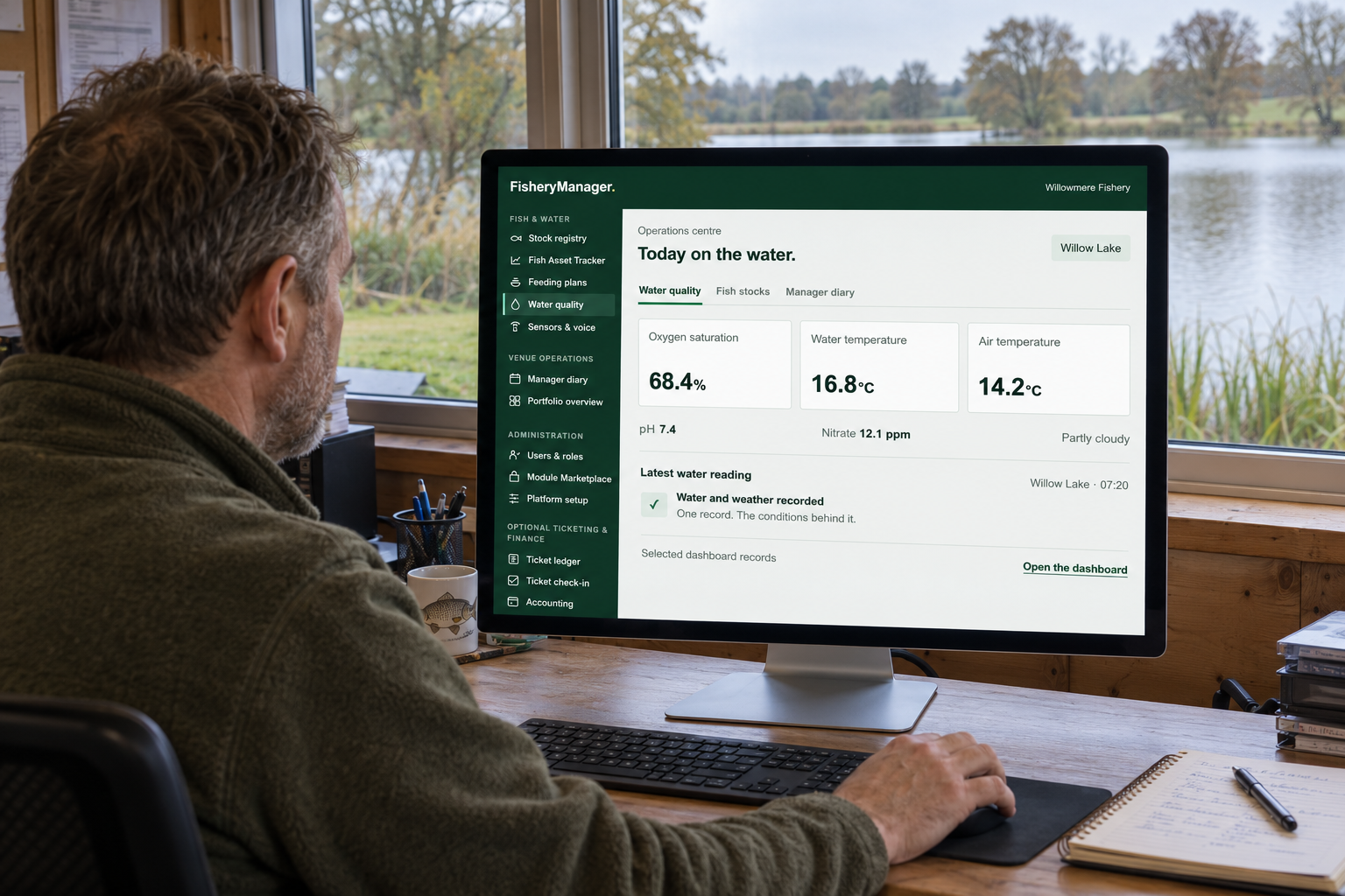 Fishery manager using the dashboard in a lakeside office, with green navigation and water quality readings on the computer screen